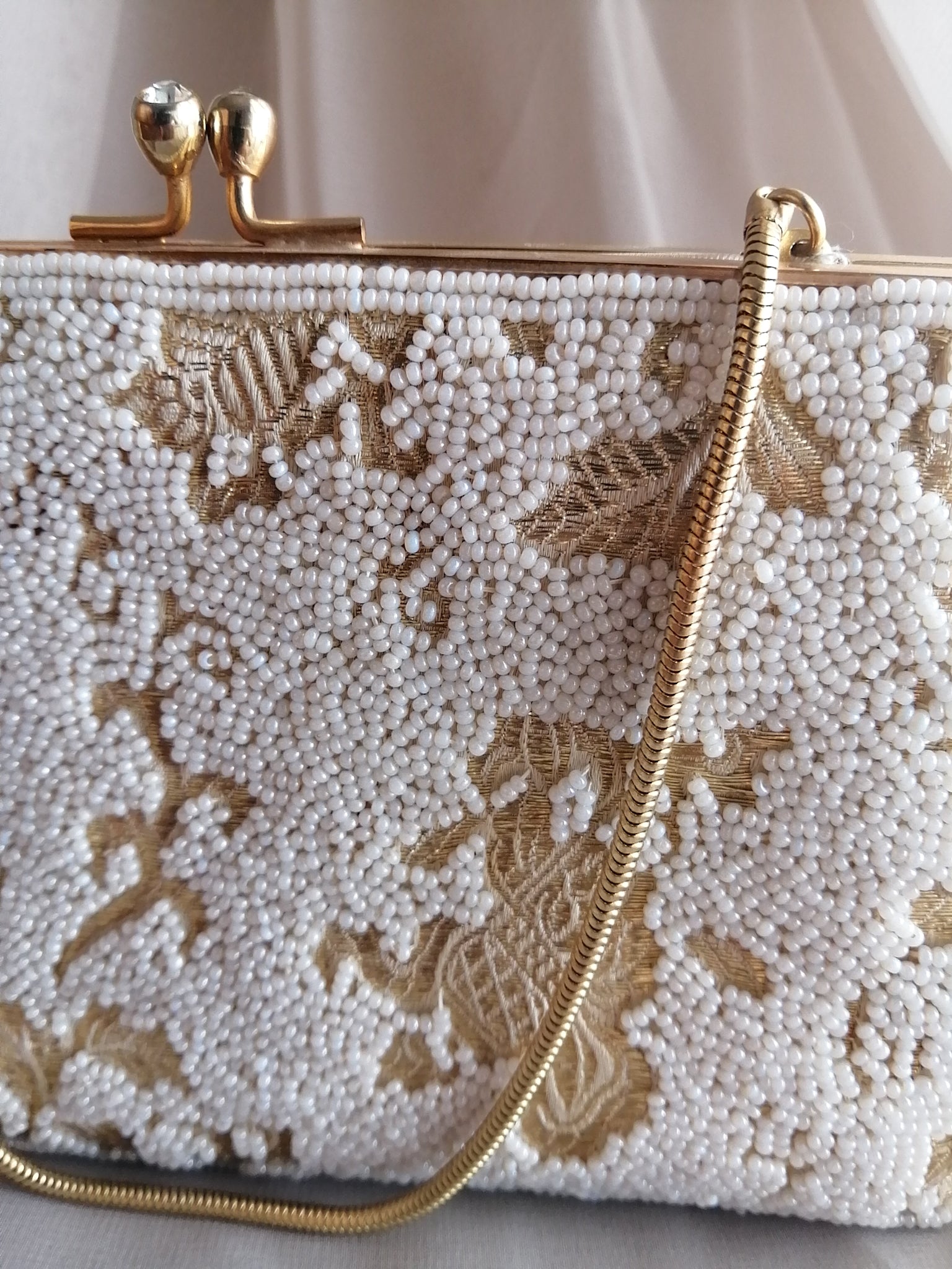White & gold beaded clutch handbag
